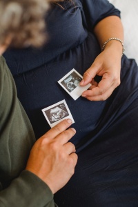 couple looking at sonogram photos of baby